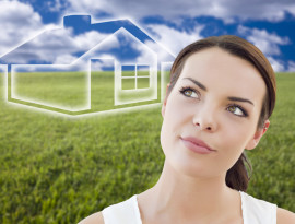 Contemplative Woman in Grass Field Looking Up and Over to the Side with Ghosted House Figure Behind.